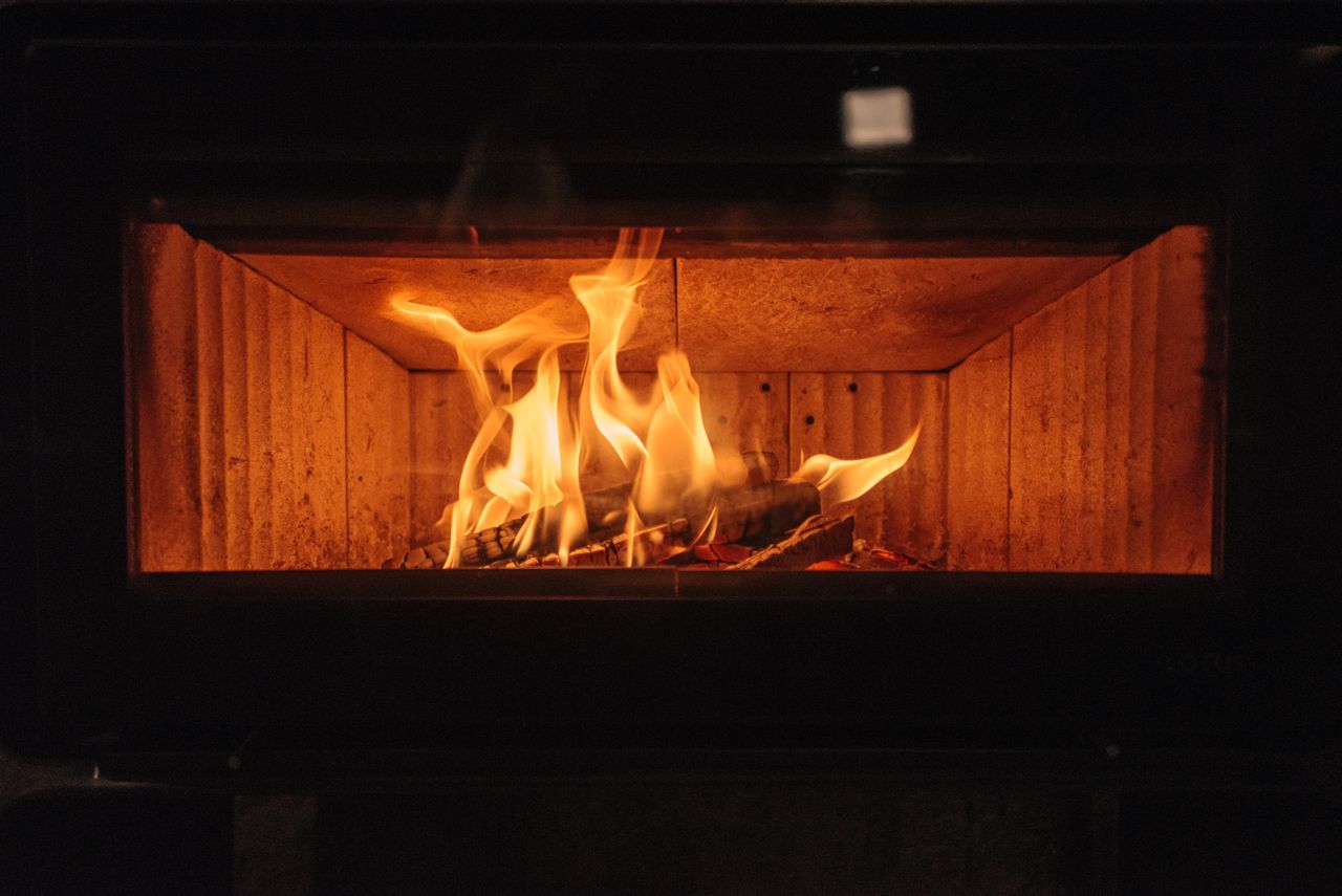 A warm and inviting fireplace featuring bright flames, perfect for cozy indoor settings.